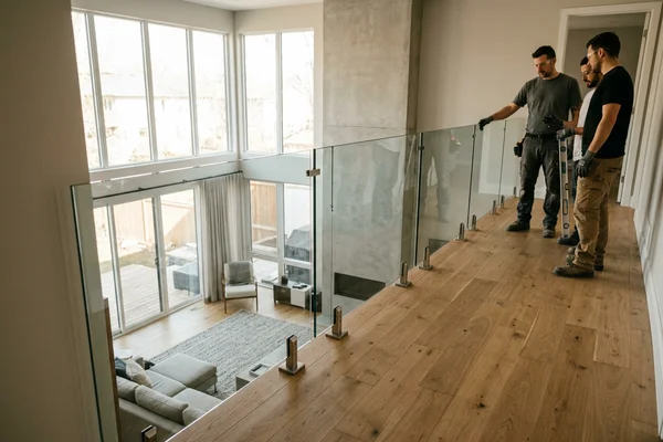 Spigot-mounted frameless glass railing along an open upper landing
