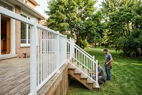 White powder-coated aluminum picket railing on a back deck and stairs